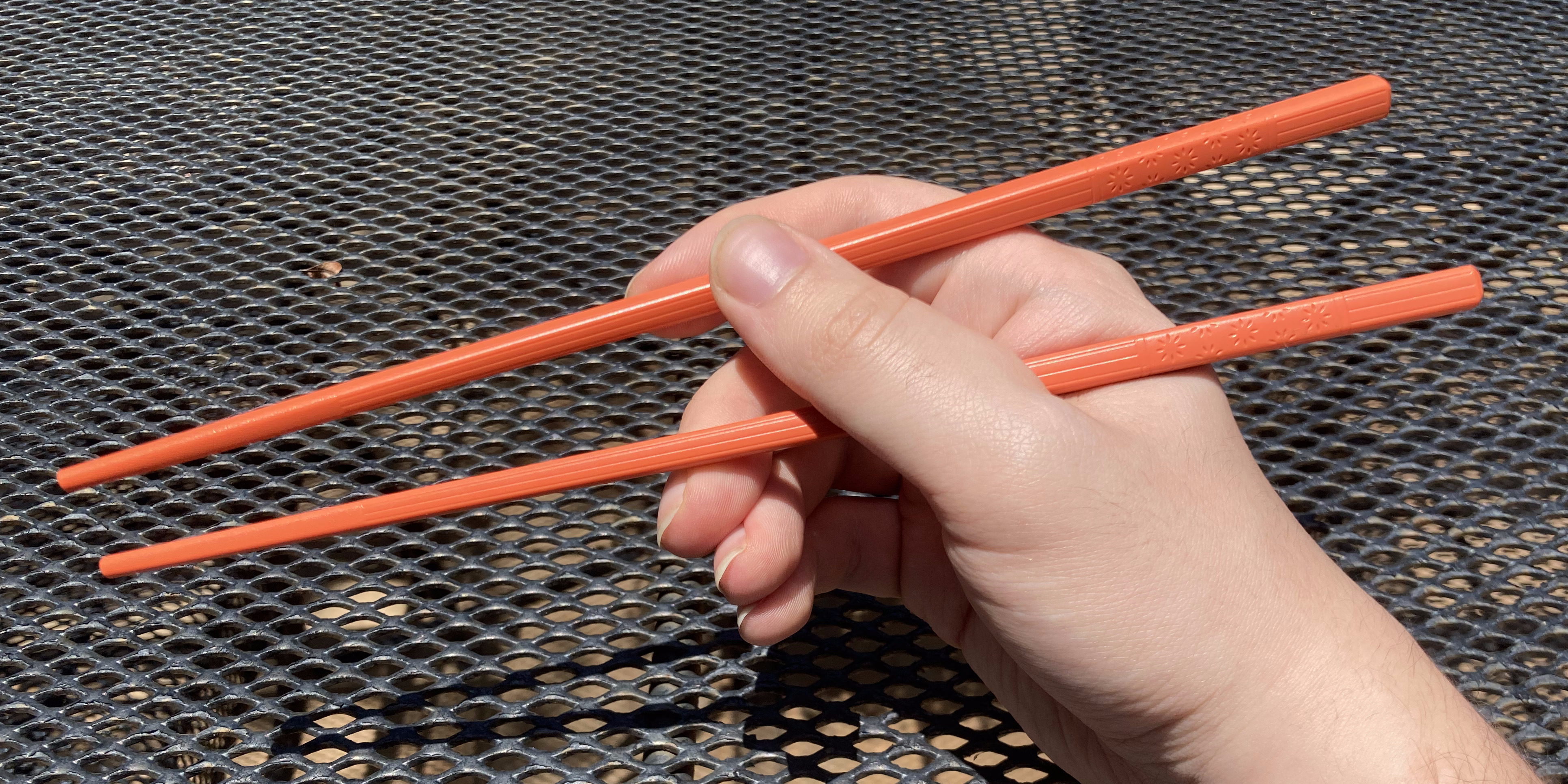 The second stick, held between my index finger and thumb.